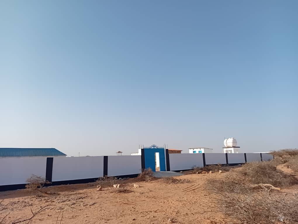 Perimeter wall, gate and elevated water tank on a completed compound