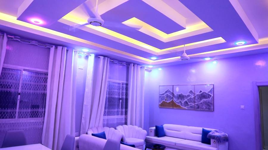 Finished reception room with recessed lighting and furniture