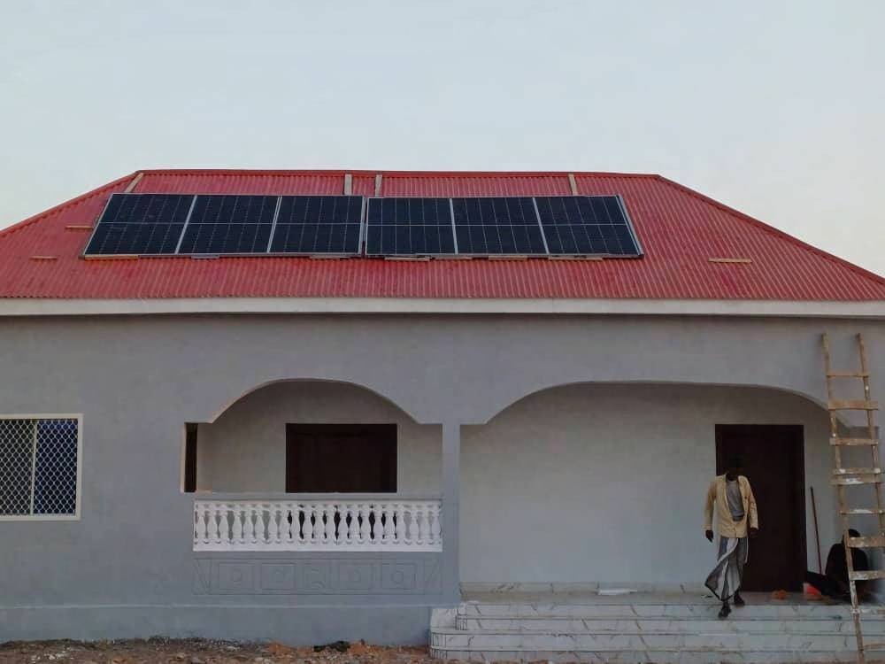 Completed house with a roof-mounted solar array
